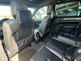 the back seats of a car with a television in the back