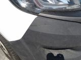a close up of a car ' s headlight and front bumper