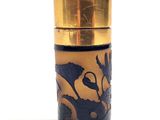 a close up of a glass container with a gold lid