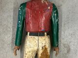 a wooden figure of a man with a hat and vest