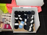 many balls of yarn in a box on the floor