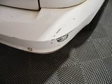 a close up of a car ' s bumper with a dent in it