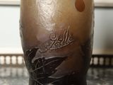 a glass vase with a brown and white design on it