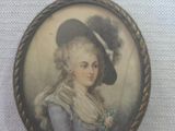 an old picture of a woman wearing a hat and holding a flower