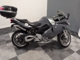 bmw motorcycle parked on a checkered tile floor in a room