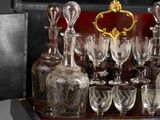 a tray with a lot of wine glasses and decanters on it