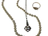 an image of a necklace and ring with pearls on a white background