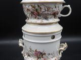 a stack of three white dishes with flowers on them