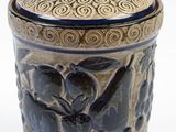 a vase with a lid that has a design on it