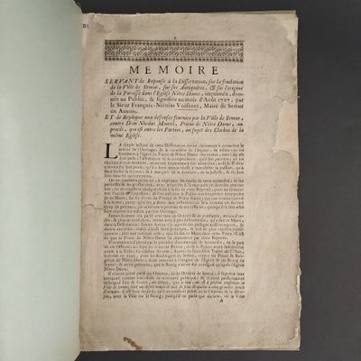 an open book on a table with a black background