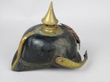 a black helmet with a gold horn on it