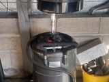 an image of a metal drum with a bucket on top of it
