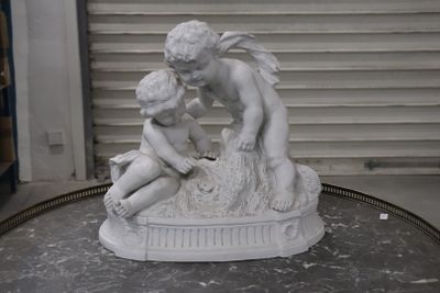 a statue of a boy and a girl sitting on a table