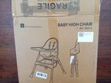 the baby high chair is in the box on the table