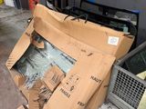a pile of cardboard and other items on the floor