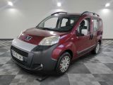 a picture of a small red van parked in a room