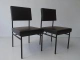 pair of black leather dining chairs with black metal legs