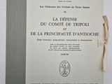 an old book with a ribbon on top of it sitting on a table