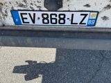 the back end of a car with a license plate on it ' s bumper