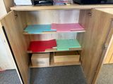 a wooden cabinet with many files and folders on it