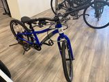 a blue bike that is parked in a room