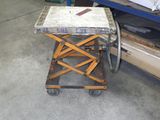 a small table with a knife on it in a garage