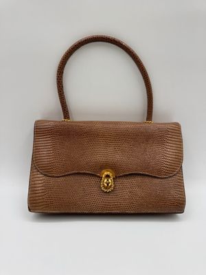 un sac à main en peau de serpent marron avec des finitions dorées