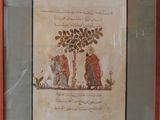 painting of two men under a tree in a red frame