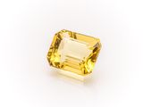 a yellow sapphire stone on a white background
