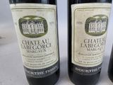 three bottles of wine are lined up on a table