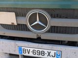 a mercedes truck that is parked on the side of the road