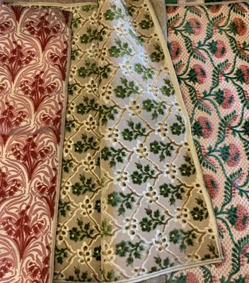 several different colors of fabric are laid out on the floor