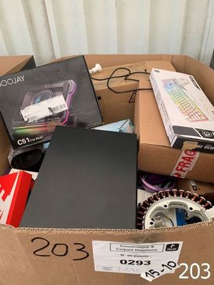 a cardboard box full of electronic equipment and a laptop