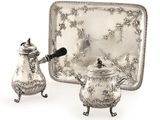 two pieces of silverware including a teapot, tray, and tray