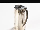 a silver coffee pot sitting on a white table