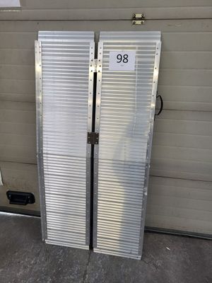 two metal doors that are open in front of a garage door