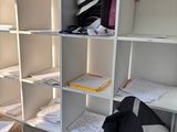 a desk with a chair and bookshelf in the corner