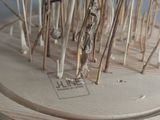 a sculpture made of dried plants on a wooden stand