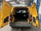 a yellow van with its doors open in a building