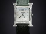 a close up of a watch on a black background