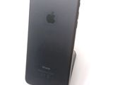 a black iphone that is sitting on top of a stand