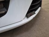 a close up of a car ' s front bumper with a remote control