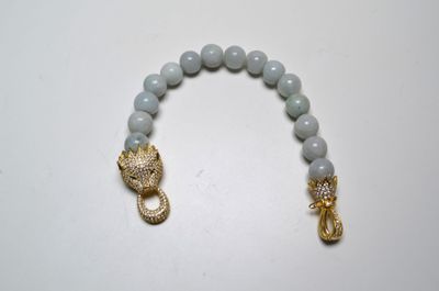un bracelet avec un fermoir doré et un bracelet en perles bleues avec un fermoir doré