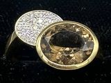 yellow gold ring with a large brown diamond surrounded by white diamonds