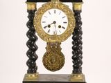 a black and gold clock sitting on top of a table