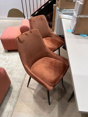 two chairs and a table in a room with boxes on the floor