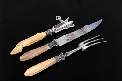 three different types of knives and a knife holder on a black surface