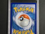 a close up of a pokemon card on a black surface