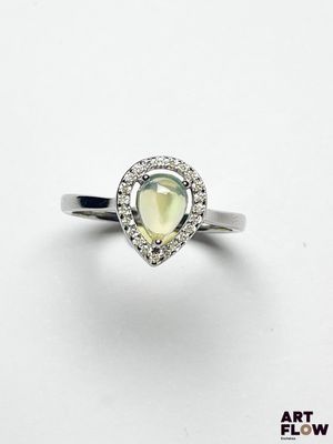un gros plan d'une bague ornée d'une pierre en forme de poire entourée de diamants