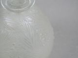 a white vase with a clear lid sitting on a table